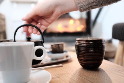 Close-up of hand holding coffee cup