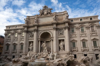 The facade of the palazzo poli and part of the trevi fountain on the roman piazza di trevi.