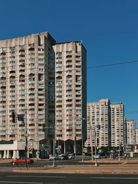 Buildings against clear blue sky in city