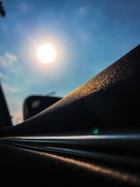 Cars on road against sky during sunset