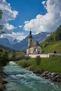 Church by building against sky