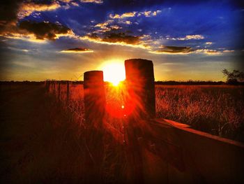 Scenic view of field against sky during sunset