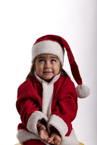 Portrait of smiling girl wearing hat against white background