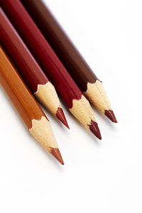 Close-up of colored pencils against white background