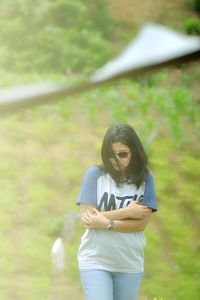 Young woman standing on field