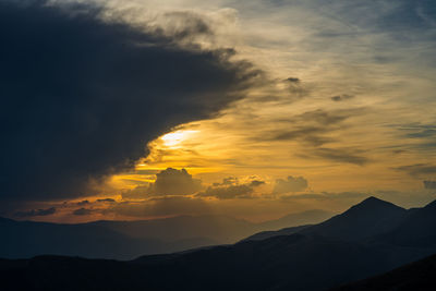 Scenic view of silhouette mountains against sky during sunset