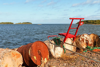 Someone has left a traditional red kicksled by the old barrels at the fishing harbour. 