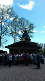 People at temple against sky