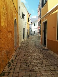 Narrow alley amidst buildings in city