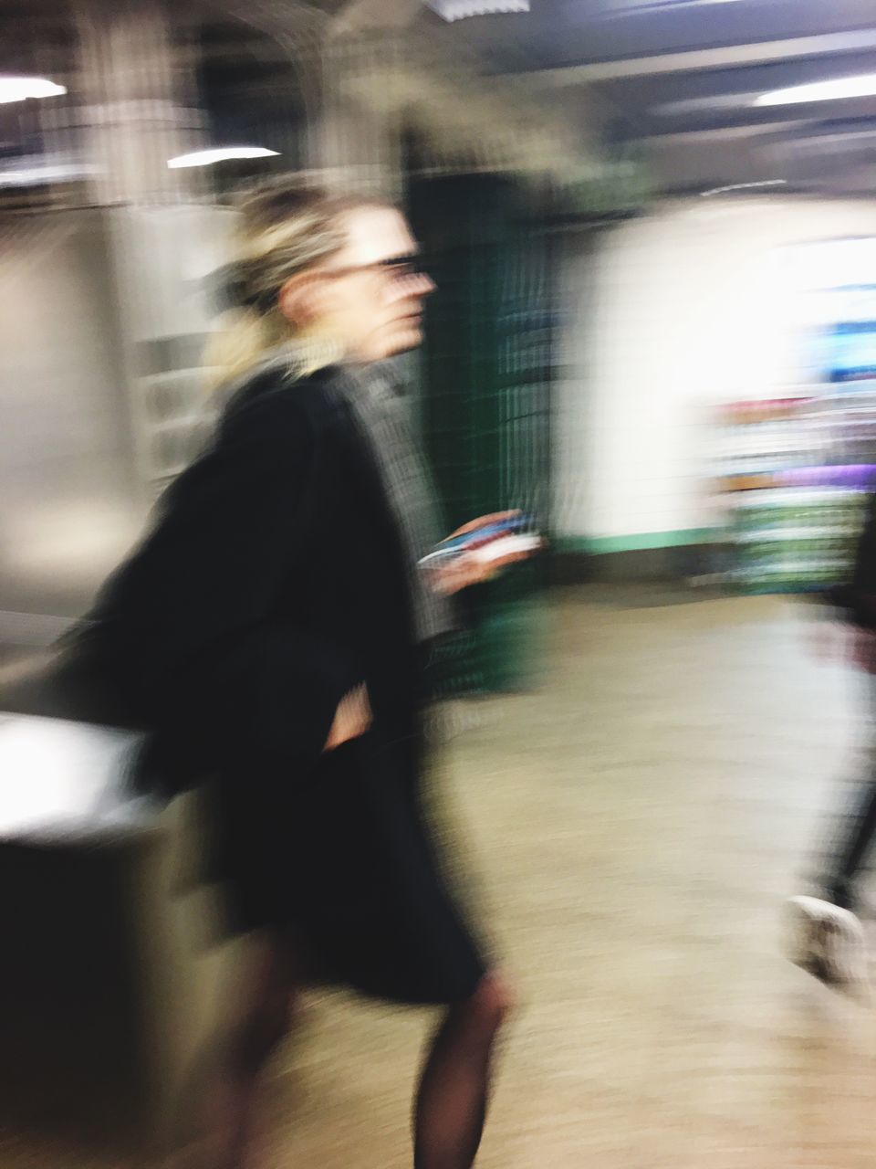 blurred motion, real people, motion, one person, transportation, side view, on the move, commuter, indoors, travel, journey, train - vehicle, lifestyles, urgency, public transportation, railroad station, railroad station platform, speed, mode of transport, land vehicle, standing, men, women, subway train, adults only, day, adult, people