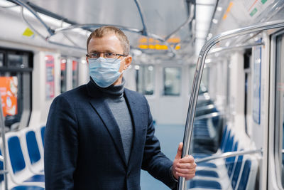 Businessman standing in train