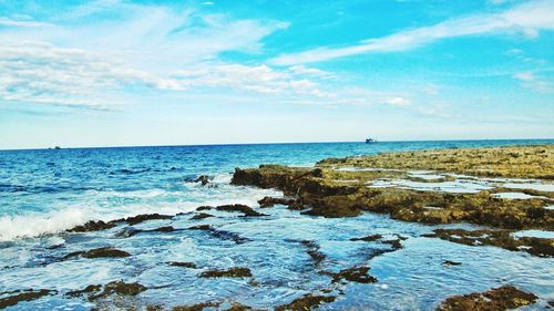 Scenic view of sea against blue sky