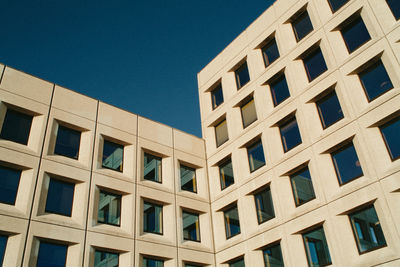 Low angle view of office building against clear sky