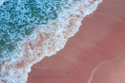 High angle view of waves rushing towards shore