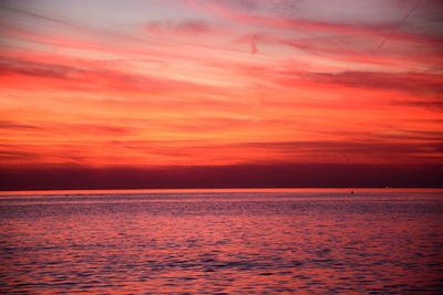 Scenic view of sea against romantic sky at sunset