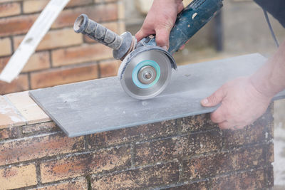 Cropped hand of man working with grinder