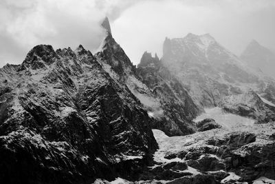 Scenic view of mountains against cloudy sky