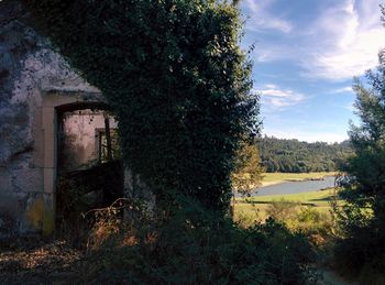 Abandoned built structure on landscape against sky