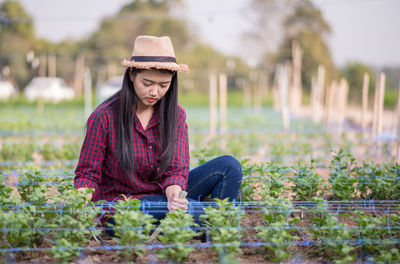 Woman wearing hat while standing on field