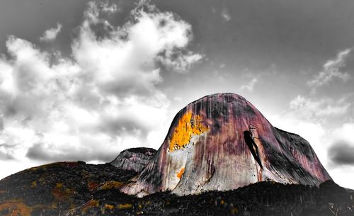 Low angle view of rock formation on mountain against sky