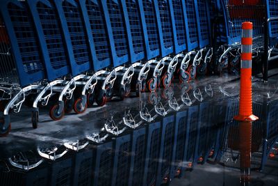 Shopping carts arranged in row reflecting on water