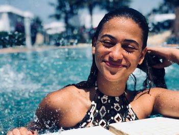 Portrait of a smiling young woman in swimming pool