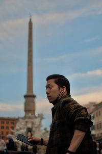 Rear view of man standing against sky