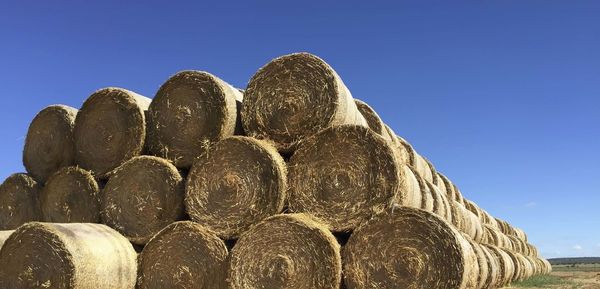 Low angle view of hay stack against sky