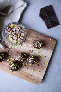 High angle view of chocolate pistachio truffle with ingredients on kitchen counter