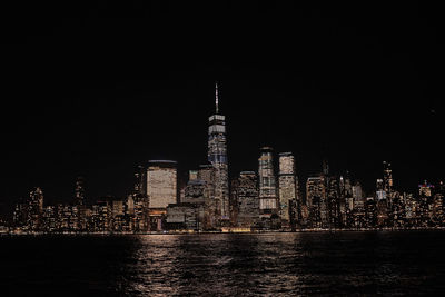 Illuminated buildings against sky at night