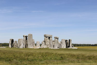 Old ruins on field against sky