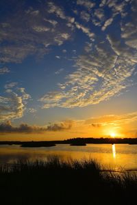 Scenic view of lake against sky during sunset