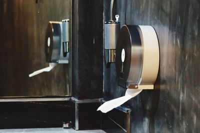 Close-up of toilet paper on wall in bathroom