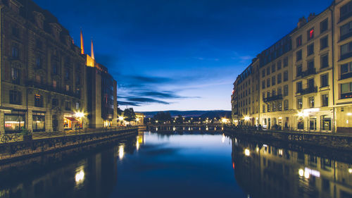 Reflection of buildings in city at night