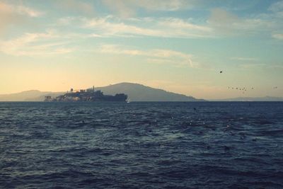 Scenic view of sea and mountains against sky