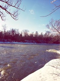 Scenic view of lake against sky during winter