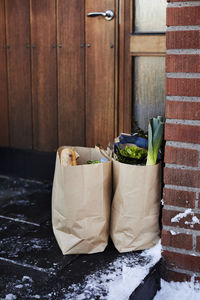 Groceries in paper bags in front of house door