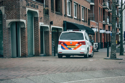 Car on street against buildings in city