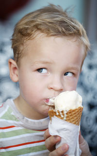 Close-up portrait of cute girl holding ice cream