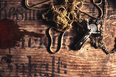 High angle view of jesus christ chain on wooden table