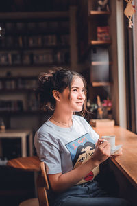 Young woman holding mobile phone