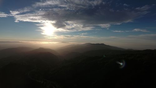 Scenic view of silhouette mountains against sky at sunset