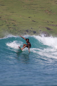 Full length of shirtless man in sea