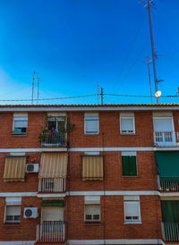 Low angle view of building against blue sky