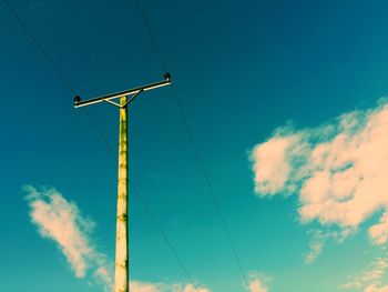 Low angle view of windmill against blue sky