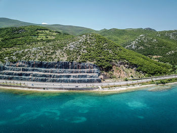 Scenic view of swimming pool by lake against sky