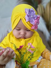 Cute girl with yellow flower