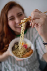 Portrait of woman holding ice cream in bowl