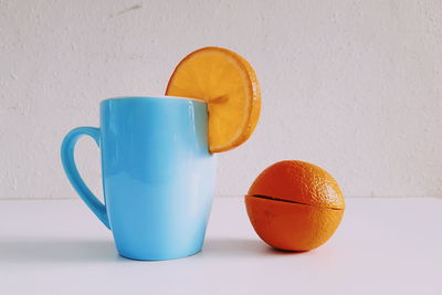 Close-up of orange drink against white background