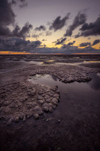 Scenic view of beach against sky during sunset